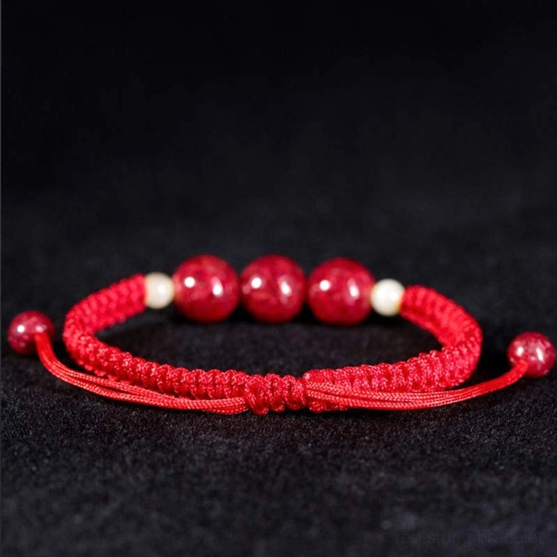 Red cinnabar blessing bracelet with large beads and light yellow spacers, adjustable drawstring tassel