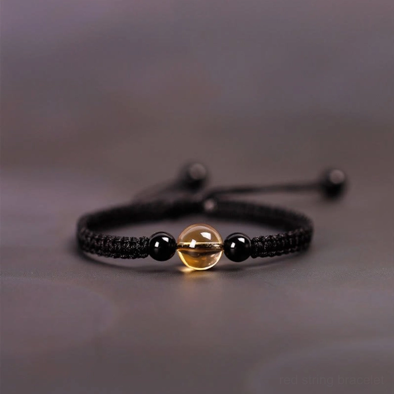 Citrine black obsidian red string bracelet detail shot of woven texture