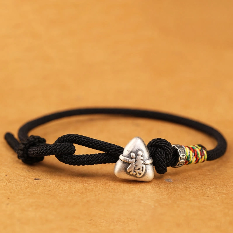 Classic black fu zongzi luck bracelet flat view on solid background