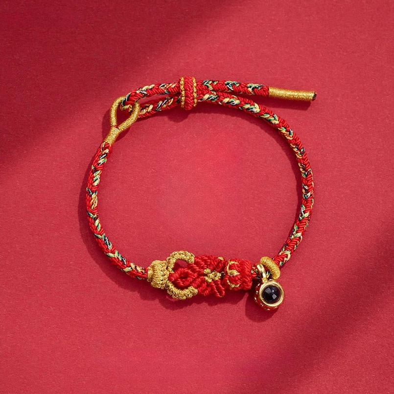 Red gold braided Buddha knot red string bracelet with traditional knot details