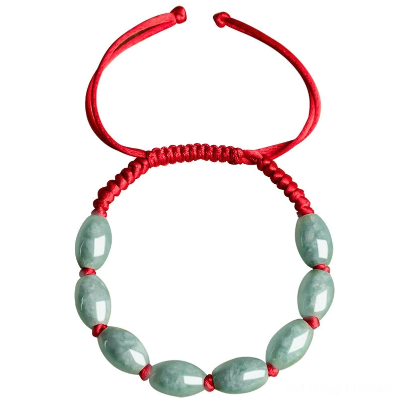 Overhead flat lay of symmetrical design jade red string bracelet on white background