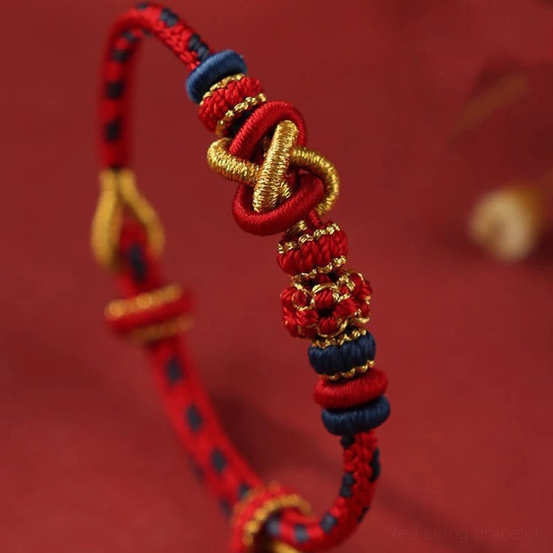 Close Up Side View Of Handwoven Peace Knot Red String Bracelet With Gold Accents