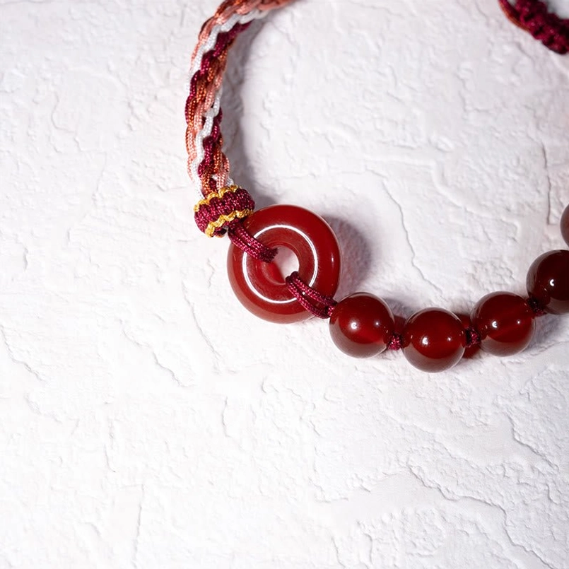 Close Up Red Agate Peace Buckle Detail On Red String Bracelet