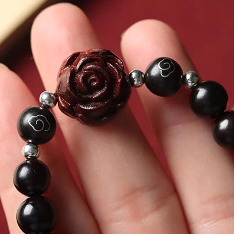 Coiled red sandalwood protection bracelet full flat lay view on red fabric