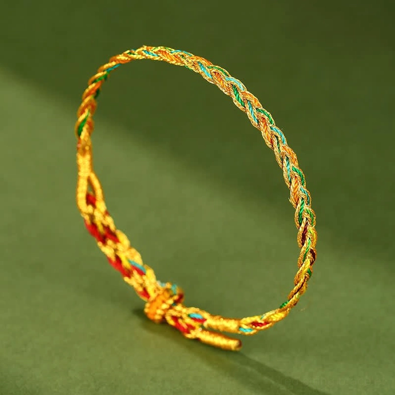 Colorful braided luck bracelet with knotted adjustable end and metallic braided cord detail, showcasing woven rainbow pattern on dark green backdrop