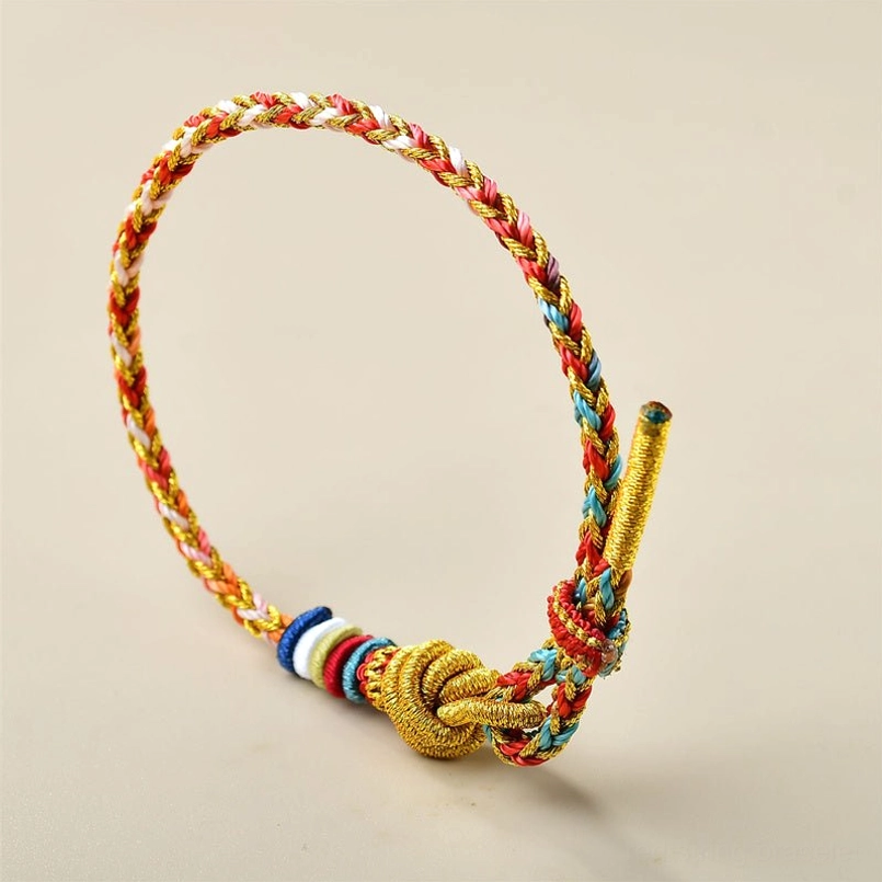 Close up view of adjustable colorful braided red string bracelet knotted end