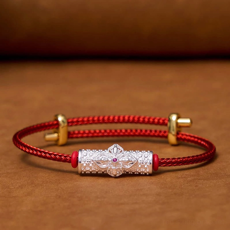 Red string bracelet with colorful flower charm variant showing enamel design detail