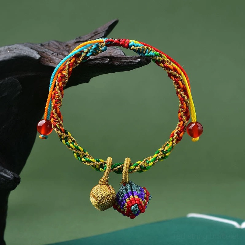 Side view of handcrafted colorful rope bracelet with zongzi charm and red bead adjusters