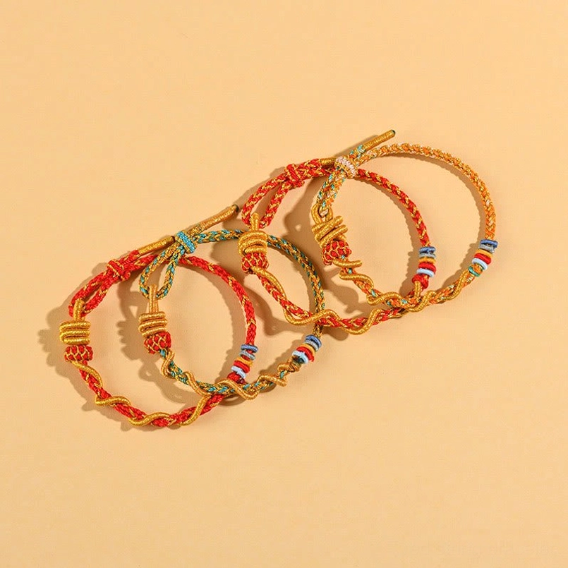 Complete Year of the Snake luck bracelet collection showing color variety and knot styles