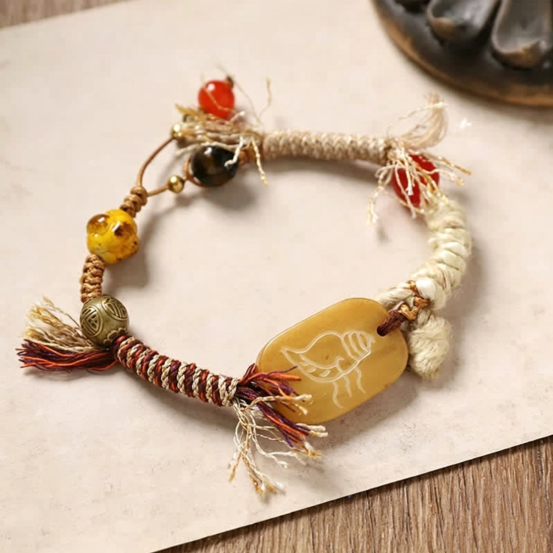 Beige bone bracelet with carved rectangular Fu charm and natural rope design