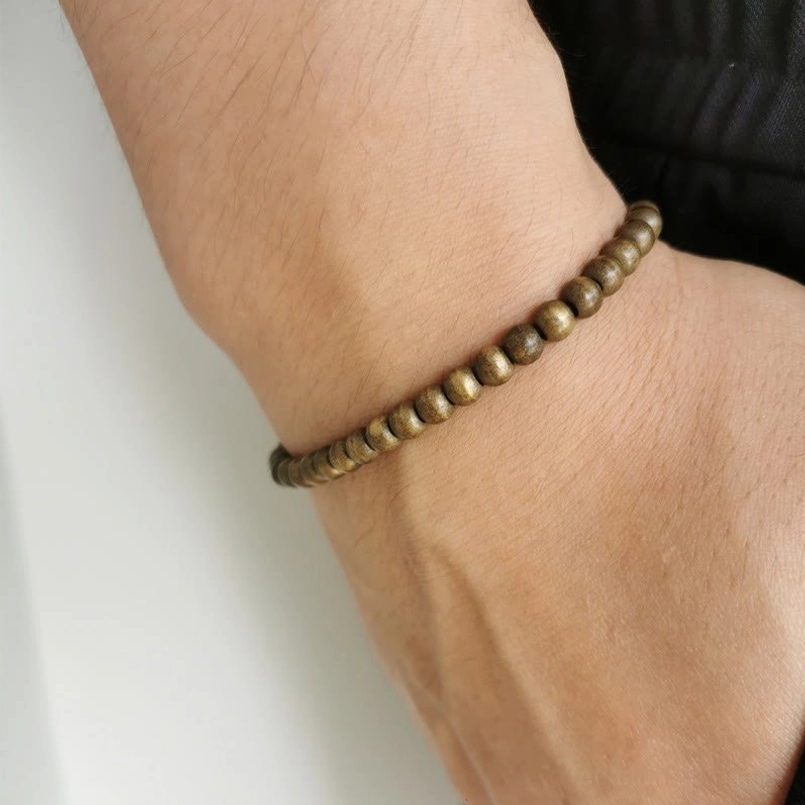 Slim fit copper brass bead red string bracelet worn on human wrist