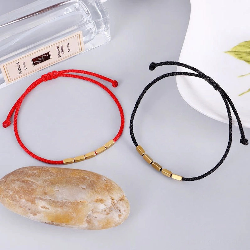 Minimalist red and black string bracelets with copper beads and natural styling