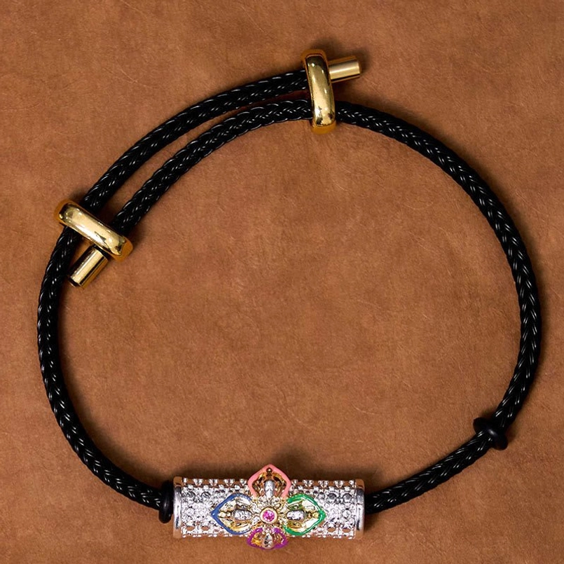 Copper luck bracelet with black cord and detailed enamel flower charm display