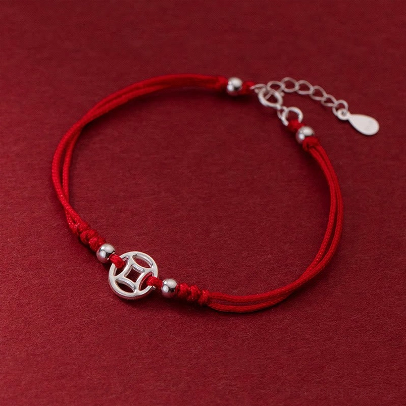 hollow copper coin charm red string bracelet with adjustable tail chain close-up