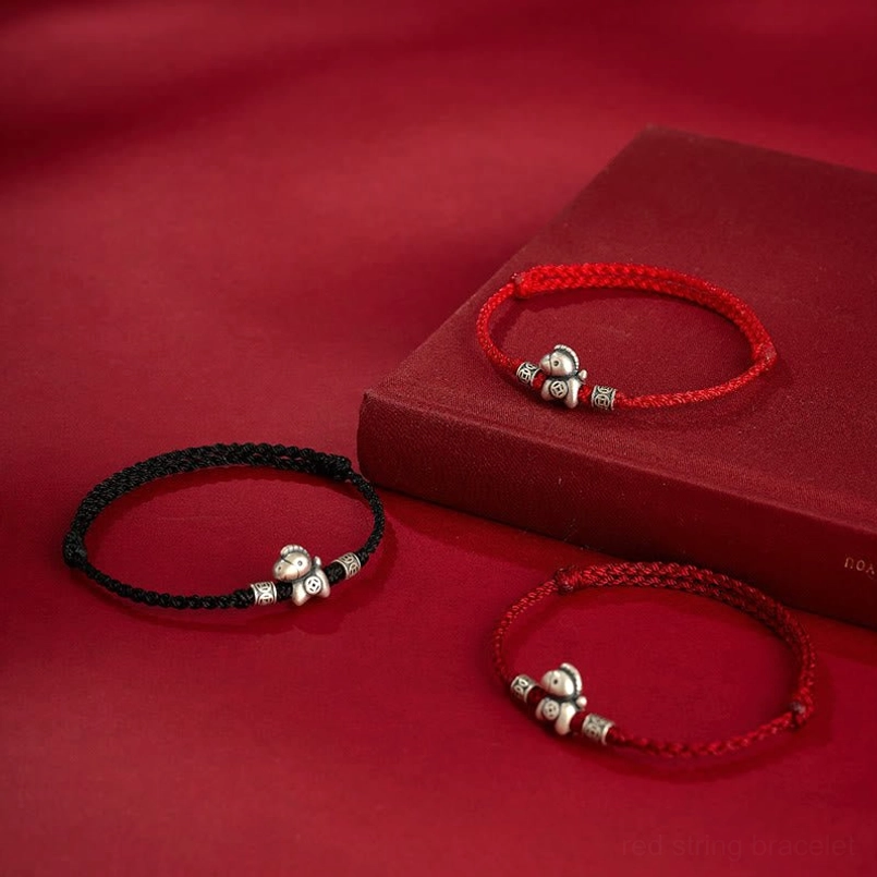 Copper coins charm detail on dark red horse zodiac bracelet