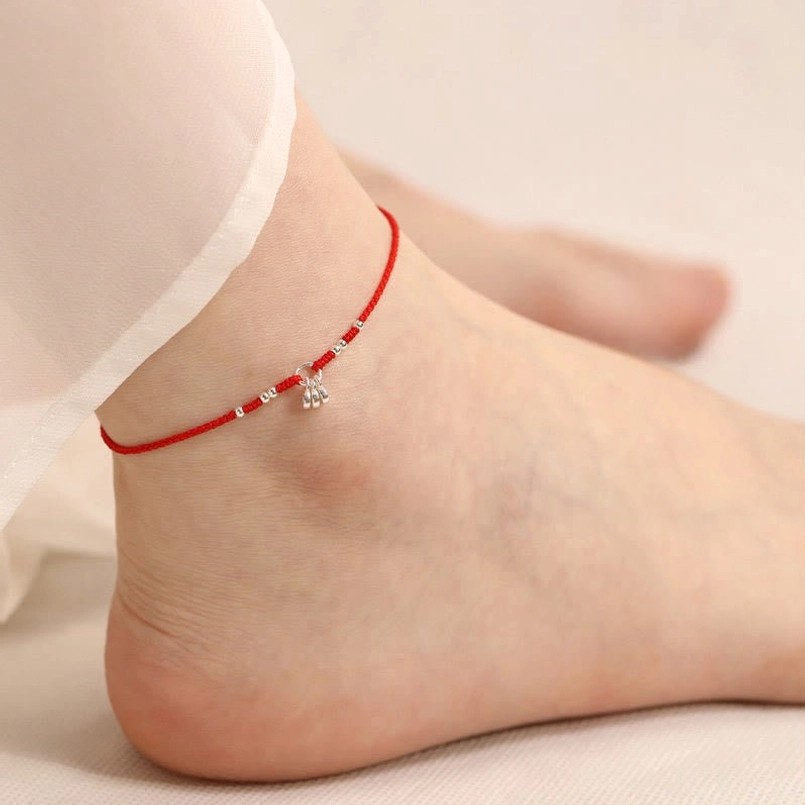 Ancient copper coins red string ankle bracelet worn on female ankle with silver beads and fortune charm