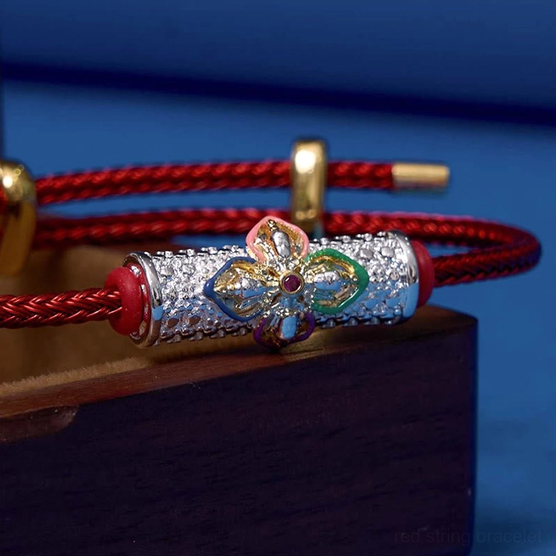 Close-up detail of copper flower charm with colorful enamel petals and silver-toned bead