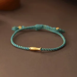 Copper koi fish luck bracelet turquoise braided rope with gold charm flat lay top view