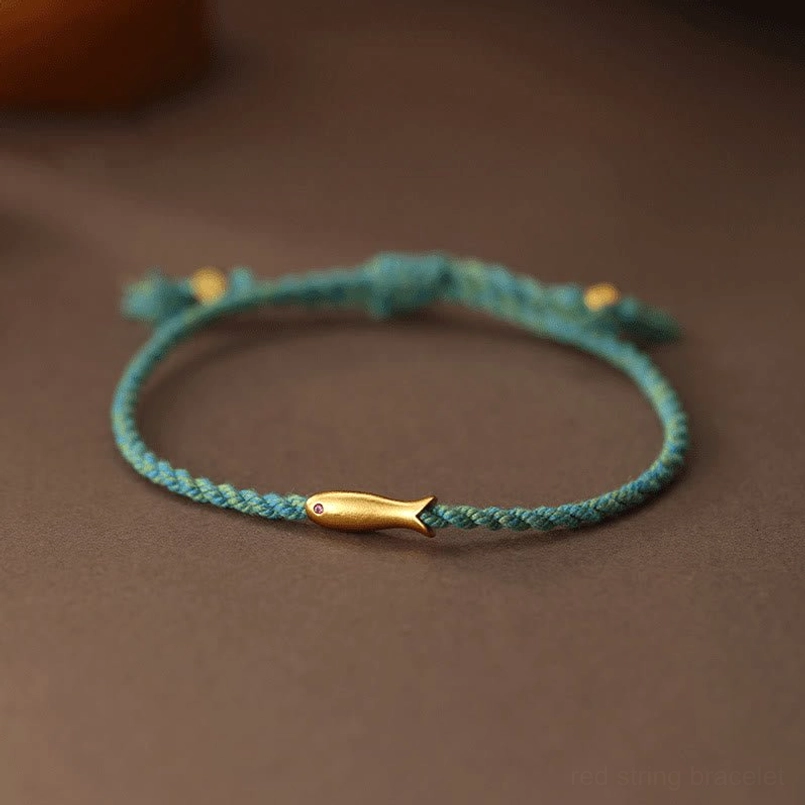 Copper koi fish luck bracelet turquoise braided rope with gold charm flat lay top view