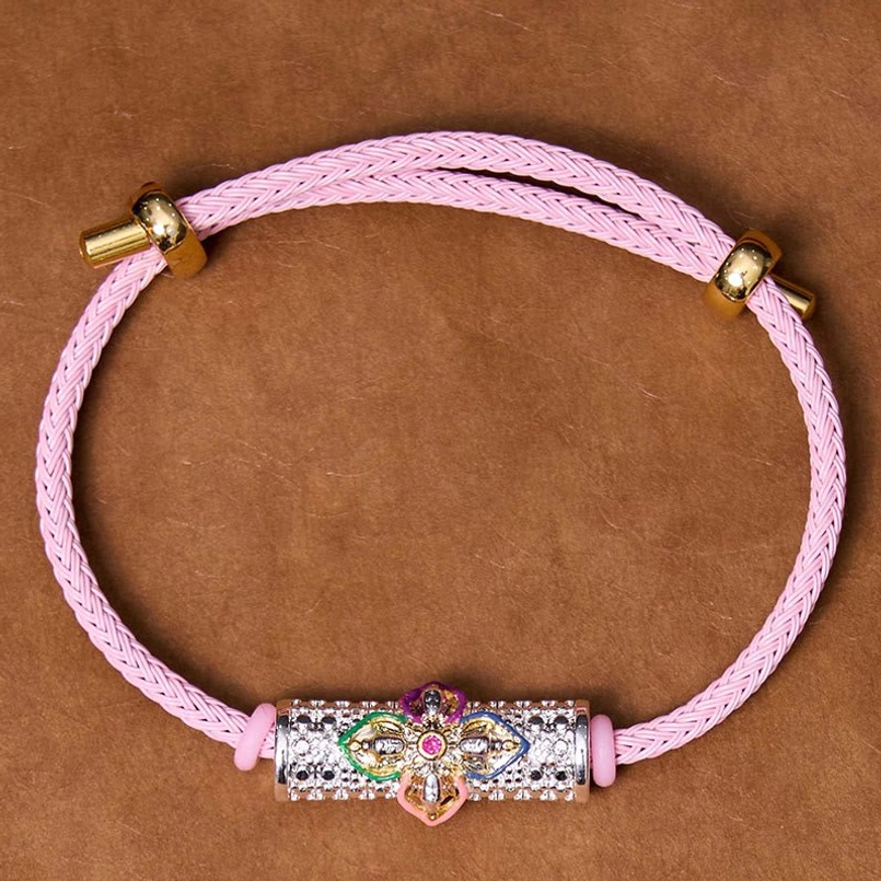 Copper luck bracelet with pink cord and colorful flower charm variant display