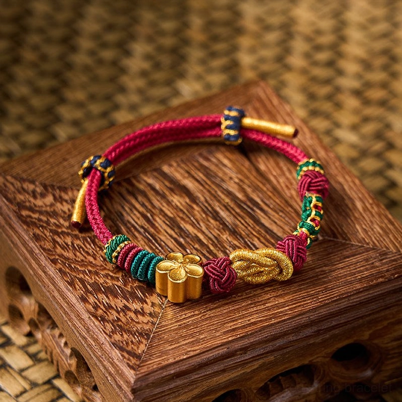 Chinese knot couple bracelet featuring dual gold ornaments and multicolor woven sections
