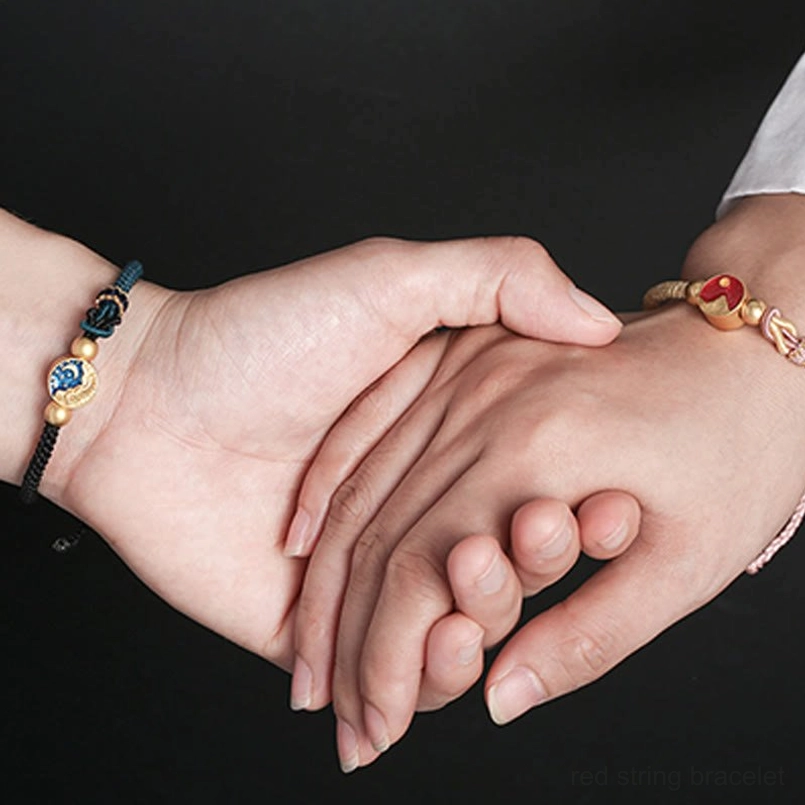Couple wearing matching mountain sea bracelets on wrists, close-up hand shot showing two color variants
