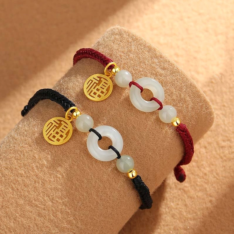 Couple matching red and black Hetian jade bracelets side by side display