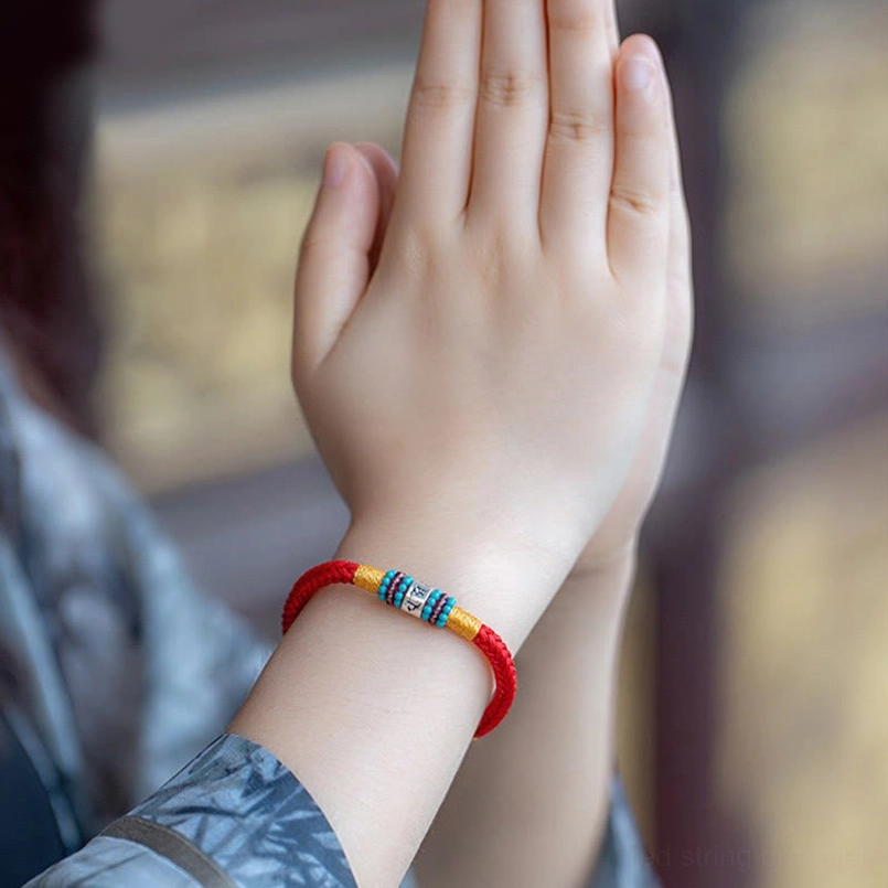 Couple matching red and black string bracelet side by side shot