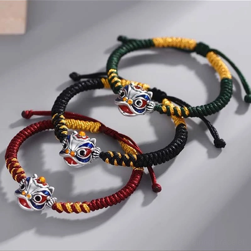 Set of dancing lion luck bracelets in red, black, and green string variants with enamel lion pendants