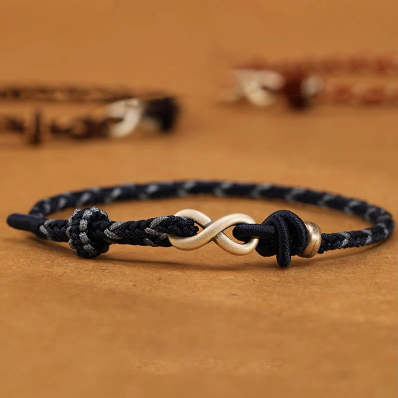 Dark blue braided cord endless knot bracelet with sterling silver infinity charm and metal accent