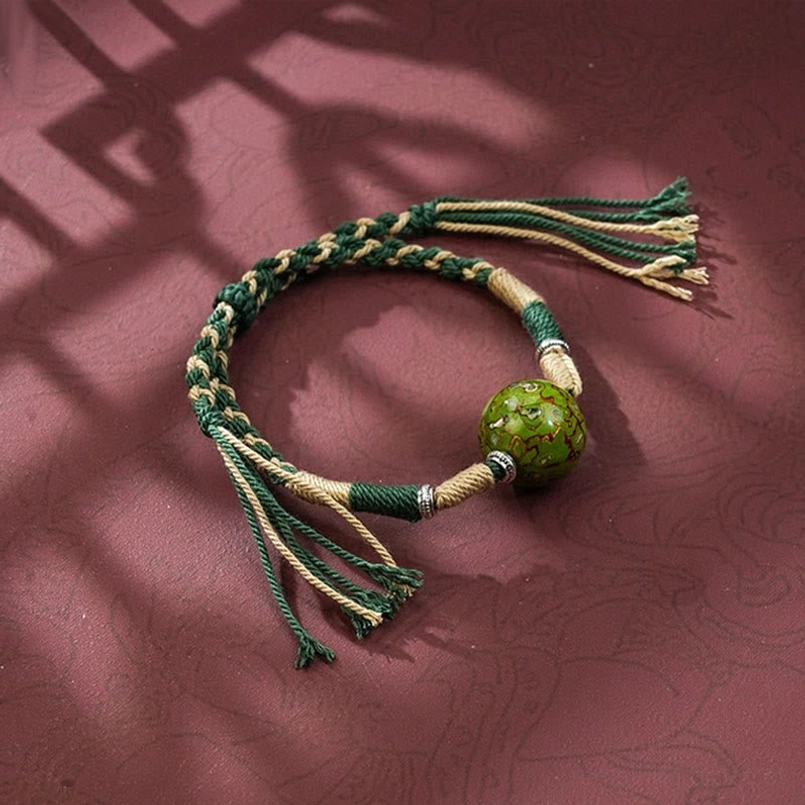 Dark green dual tone braided red string bracelet with glossy lacquer bead