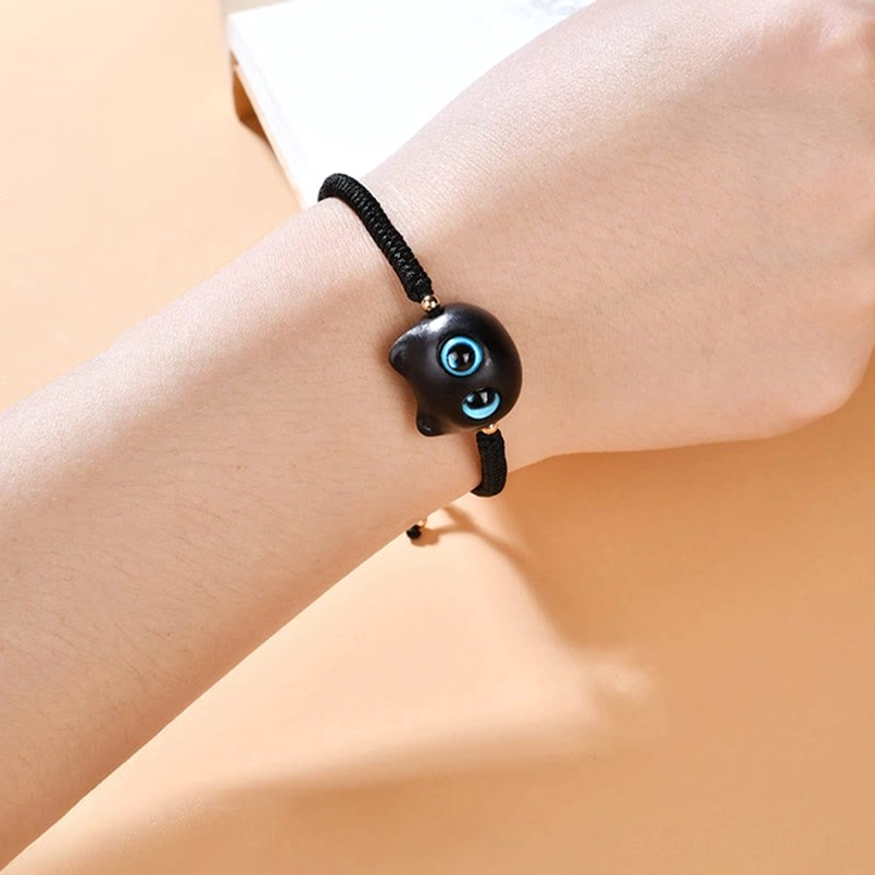 Wine red cord cat bracelet showing natural ebony wood texture and craftsmanship