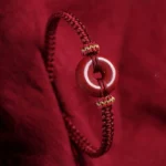 Dark red cinnabar peace buckle braided bracelet close-up side view