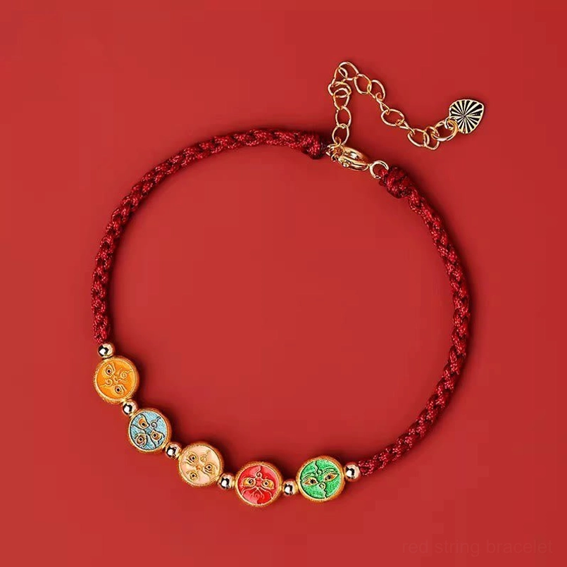 dark red string five ways god of wealth bracelet flat lay on red background