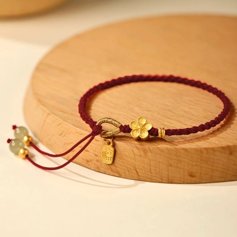 Dark red wine red Hetian jade Fu charm red string bracelet on wooden tray
