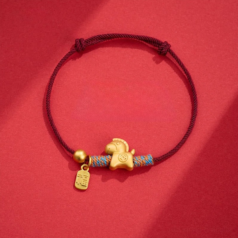 Horse Fu charm dark red string bracelet flat lay on red background
