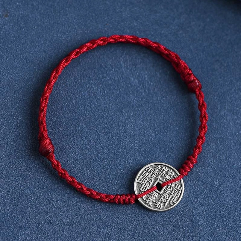 Dark red braided protective bracelet with antique silver coin centerpiece