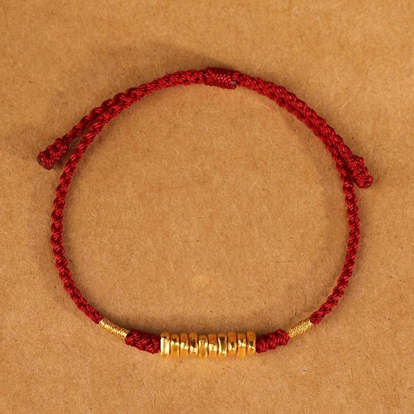 Dark red braided red string luck bracelet with gold beads top view