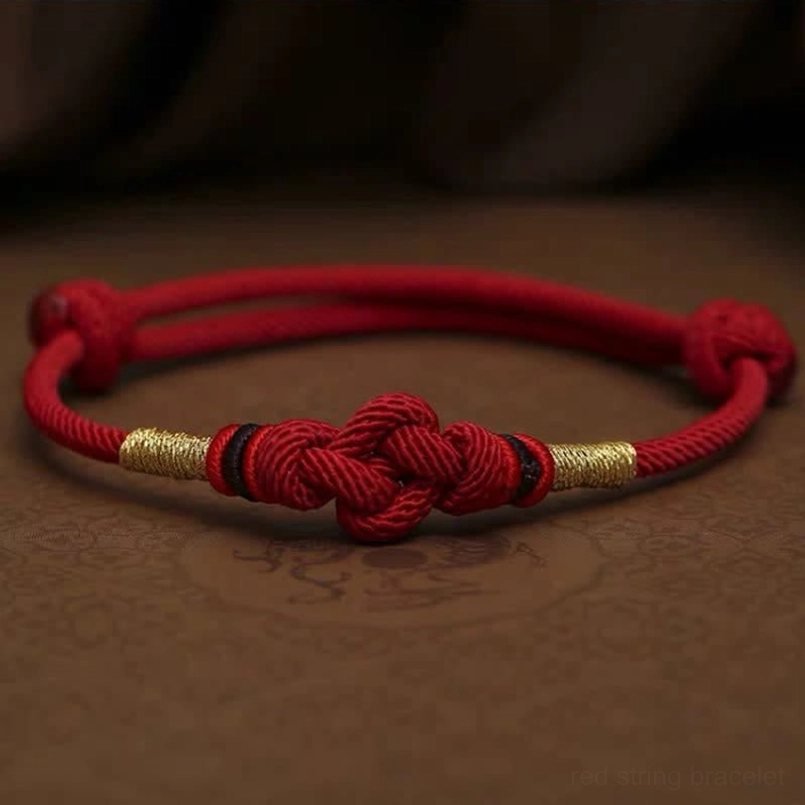 Dark red string jade bracelet variant with gold accents and prosperity knot