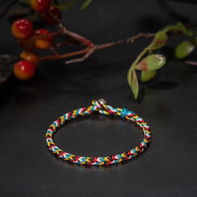 Mini delicate Tibetan five color red string bracelet side view with red berry branches