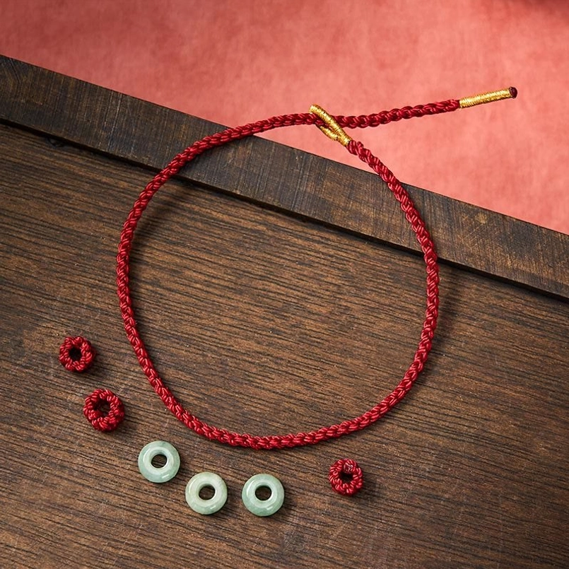 DIY red string bracelet crafting supplies loose jade beads and braided cord