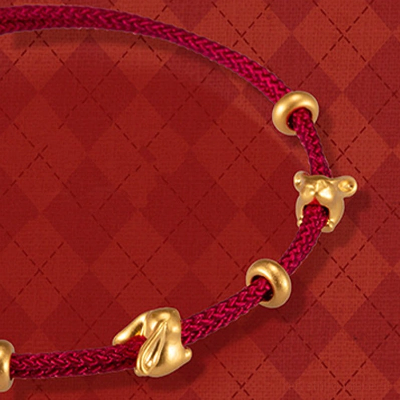double 999 gold rabbit charm red braided bracelet close up view