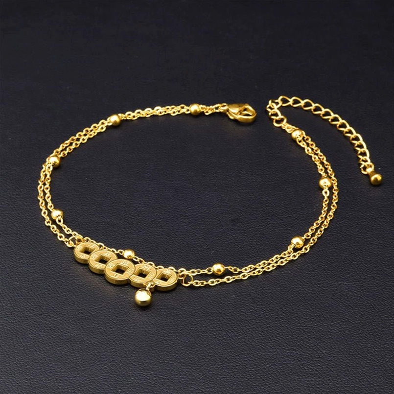Overhead view of double-layer copper coin titanium steel anklet with extension clasp on black background