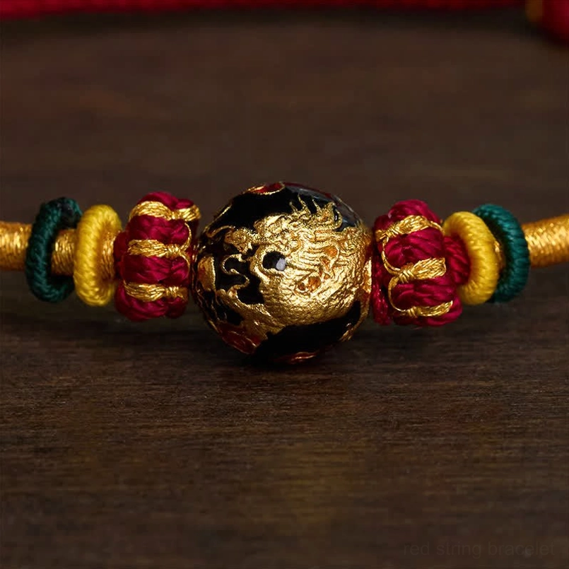 Gold dragon carved copper bead close-up showing detailed relief carving