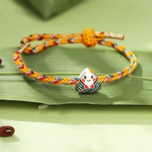 Dragon Boat Festival red string bracelet with 925 silver zongzi charm, multicolored braided rope, flat lay view