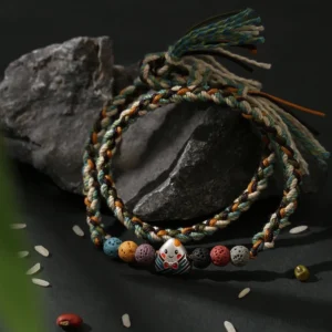 Dragon Boat Festival woven lucky bracelet flat lay on dark stone backdrop