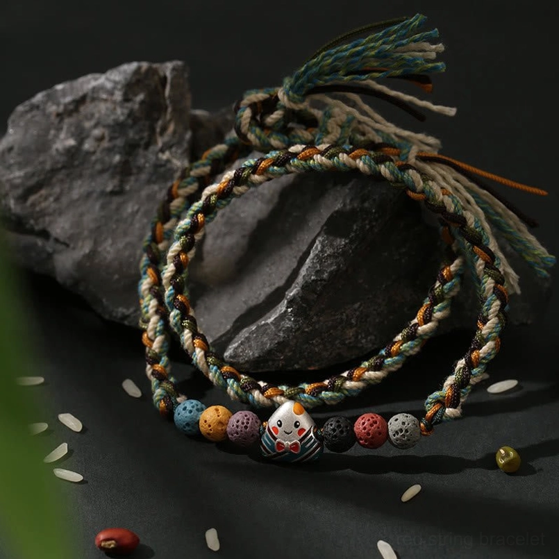Dragon Boat Festival woven lucky bracelet flat lay on dark stone backdrop