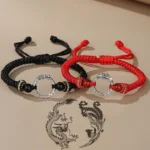 Dragon phoenix couple lucky bracelets flat lay - red and black woven cord with silver peace buckles