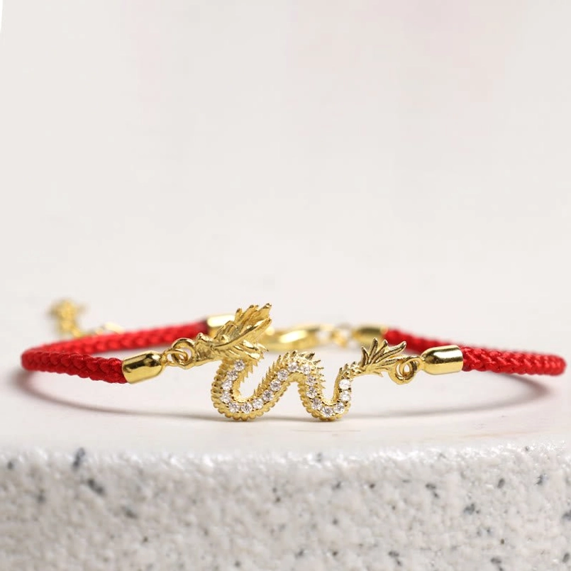 Dragon Red Rope Bracelet side view with braided cord on stone surface
