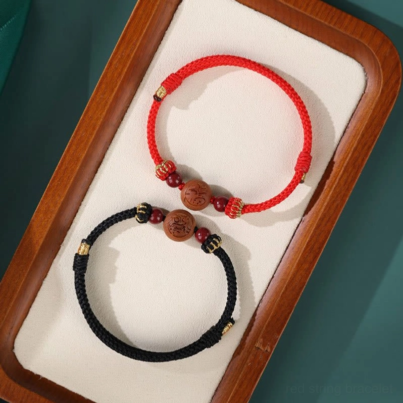 Dragon zodiac peach wood black rope bracelet - confidence and power prosperity talisman